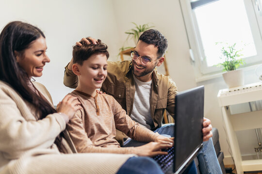 Mother, father and son looking at the laptop together