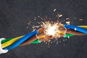 flame and sparks on electrical cable, hazard concept