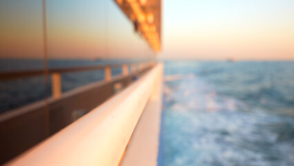 Blurred background with reflection of the sea in the floating yacht window at sunset - obrazy, fototapety, plakaty