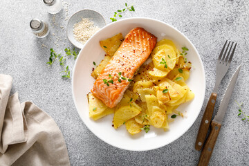 Salmon grilled and baked potato with onions, top down view - 653832500