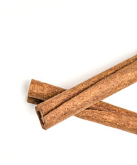 pair of cinnamon sticks next to each other (on top, cut out) isolated on white background (spices, spice, ingredient, flavoring, pie, dessert) indian cooking, spice islands