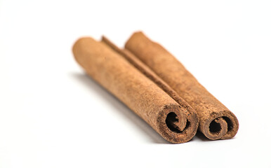 pair of cinnamon sticks next to each other (on top, cut out) isolated on white background (spices, spice, ingredient, flavoring, pie, dessert) indian cooking, spice islands