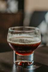 coffee shot in a transparent glass on the table close-up