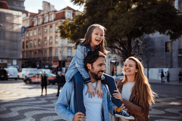 Young family having a stroll together in the city