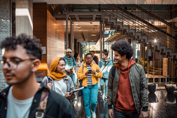 Young and diverse group of students going to class in a university hall
