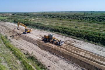 Construction of an irrigation canal. Earthworks, laying the foundation of the water channel. A...