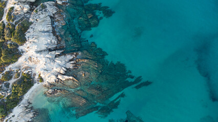 Aerial drone view of rocks, water and forest near the twin beaches of Karidi and small Karidi, Vourvourou, Sithonia peninsula, Halkidiki, North Greece