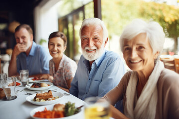 Happy senior friends having fun dining together. Elderly lifestyle people and food concept - obrazy, fototapety, plakaty