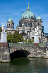 The Berlin Cathedral with a bridge over the river Spree on a sunny day