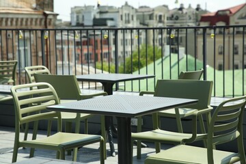 Observation area cafe. Tables and chairs on terrace against beautiful cityscape