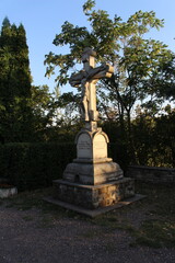 A statue of a person holding a cross