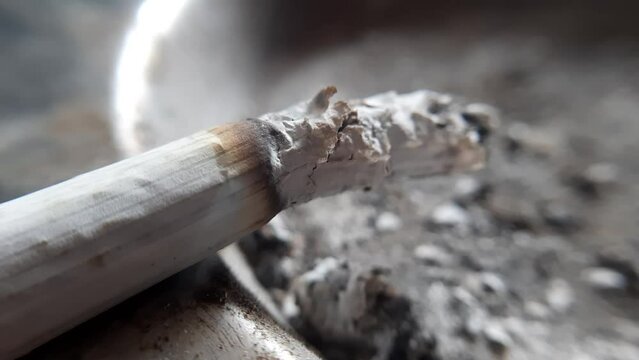 lit cigarette in the ashtray