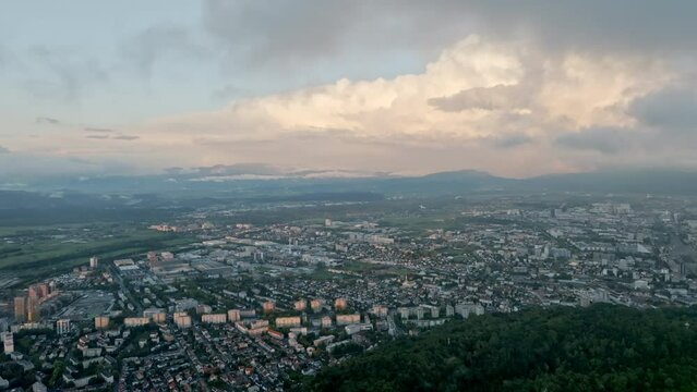 Ljubljana's city grid juxtaposed against forested expanses.
