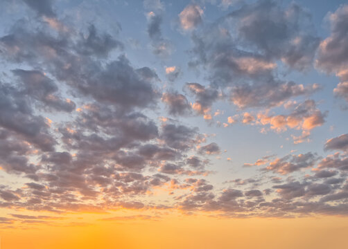 Golden hour sky with clouds. Ideal for sky replacement in modern photo editing software tools.
