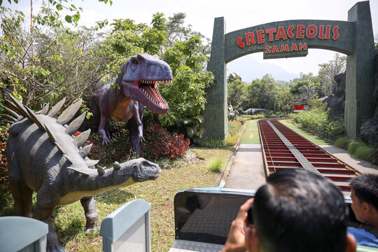 East Java, Indonesia - August 14, 2023. Fossil and Satue of a T-rex dinosaur in the Dino Park for study tour and education in Jatim Park 3, Indonesia.