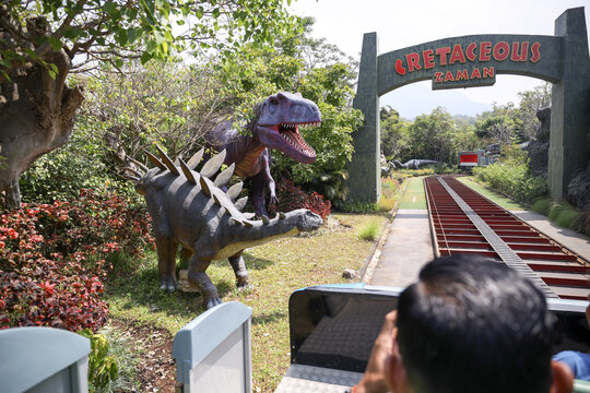 East Java, Indonesia - August 14, 2023. Fossil and Satue of a T-rex dinosaur in the Dino Park for study tour and education in Jatim Park 3, Indonesia.