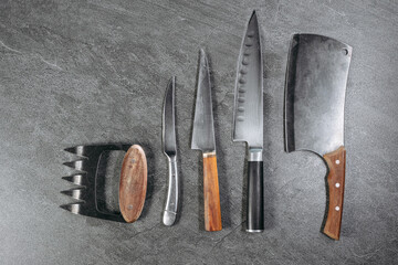 A set of professional kitchen knives consisting of a five-bladed knife, a small rounded knife, a...