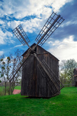 Old windmill on a green meadow.