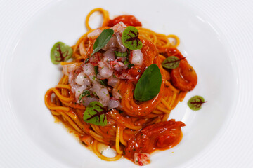Italian food speciality, spaghetti or linguni pasta seafood sauce with red prawns( gambero rosso) tartare