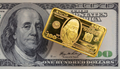 US 100 dollar golden bar die cut stamp on US 100 dollar banknote background
