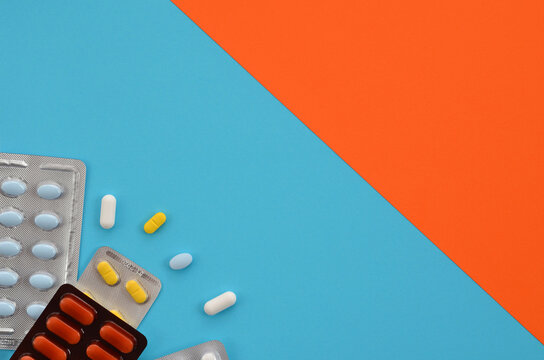 different pills on a colorful background, copy space