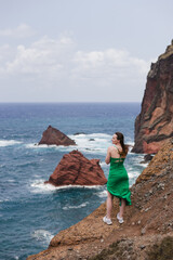 Travelling and exploring Madeira island landscapes and travel destinations. Young female tourist enjoying spectacular Ponta de Sao Lourenco view. Summer tourism by Atlantic ocean and mountains.