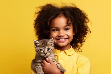 Foto op Plexiglas A cute little girl cuddles her adorable kitten, their friendship radiating love and happiness in a cozy home. © Andrii Zastrozhnov