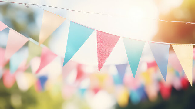 Triangular holiday flags on a string on street home party, blurred background. Colorful Holiday party decorations for backyard party. 