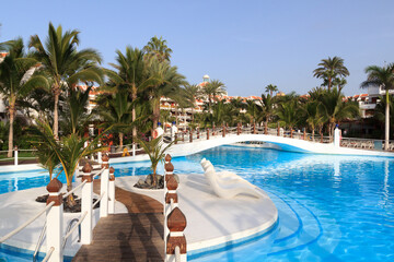 Hotel resort panorama with swimming pool and palm trees in Playa de las Americas, Tenerife