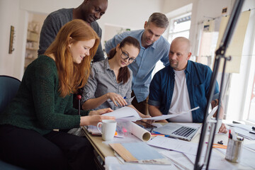 Group of people working together on a project in a startup company office