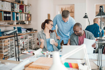 Group of people working together on a project in a startup company office