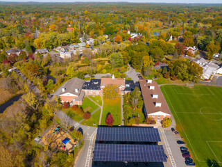 Wayland Town Hall aerial view in fall with fall foliage at 41 Cochituate Road in historic town...