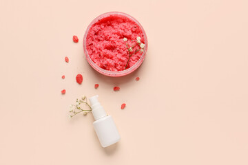 Composition with jar of body scrub, bottle of cosmetic product and gypsophila flowers on color background