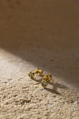 Gold jewelry on a stone background