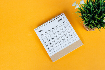 March 2024 desk calendar on yellow background. Directly above. Flat lay.