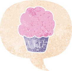 cartoon cupcake with speech bubble in grunge distressed retro textured style