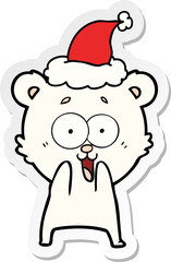 excited teddy bear hand drawn sticker cartoon of a wearing santa hat