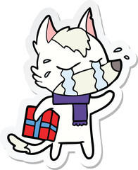 sticker of a cartoon crying wolf with christmas present