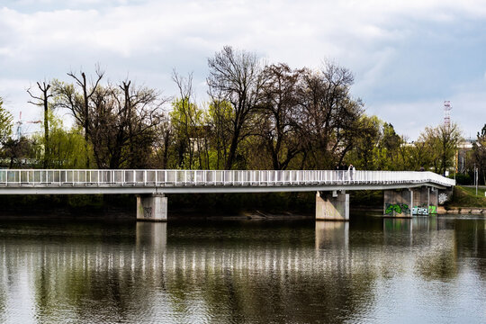 Pedestrian bridge in Bordei park over the lake. Bucharest, Romania.