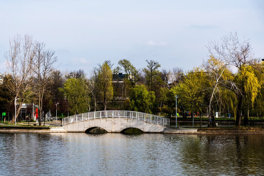 Pedestrian bridge in Bordei park over the lake. Bucharest, Romania.