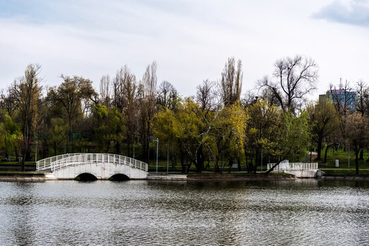 Pedestrian bridge in Bordei park over the lake. Bucharest, Romania.