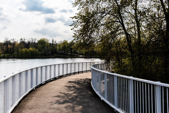 Pedestrian bridge in Bordei park over the lake. Bucharest, Romania.