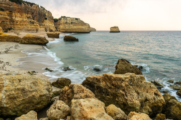 Rocky cliffs on sandy Marinha Beach in Algarve coast at Atlantic Ocean in Portugal