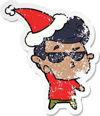 hand drawn distressed sticker cartoon of a cool guy wearing santa hat