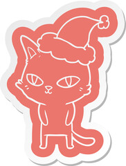 quirky cartoon  sticker of a cat with bright eyes wearing santa hat