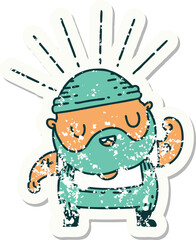 worn old sticker of a tattoo style bearded man flexing bicep