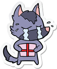 sticker of a cartoon crying wolf with christmas present