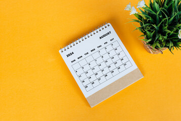 August 2024 desk calendar on yellow background. Directly above. Flat lay.