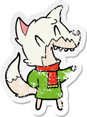distressed sticker of a laughing fox wearing winter clothes