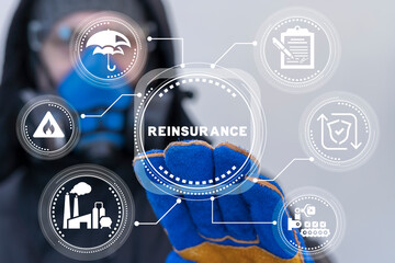 Worker or engineer using virtual touch interface presses word: REINSURANCE. Industrial concept of reinsurance. Ceding company. Treaty insurance. Risk management on manufacturing. Success insurance.